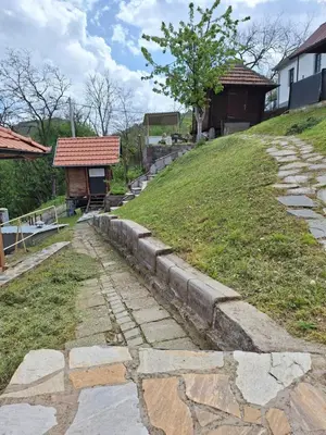 a stone path leading up a hill with a building at Vila Kojzak in Bela Stena