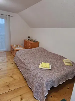 a bedroom with a bed with two towels on it at Vila Kojzak in Bela Stena