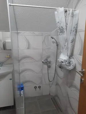 a shower with a glass door in a bathroom at Vila Kojzak in Bela Stena