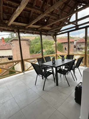 a table and chairs on a patio with a view at Miljaca in Pirot
