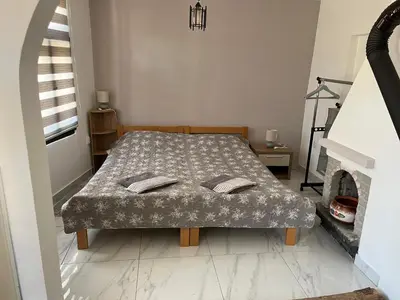 a bedroom with a bed and a fireplace at Miljaca in Pirot