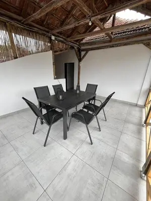 a black table and chairs in a room at Miljaca in Pirot