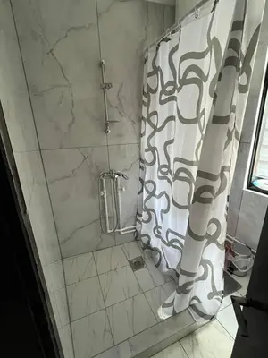 a shower with a shower curtain in a bathroom at Miljaca in Pirot