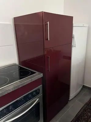 a kitchen with a red refrigerator and a sink at Miljaca in Pirot