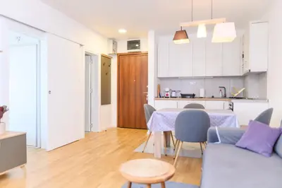 a living room and kitchen with a table and a couch at Viktor i Kasija green hill in Soko Banja