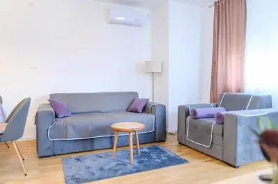 a living room with a couch and a table at Viktor i Kasija green hill in Soko Banja