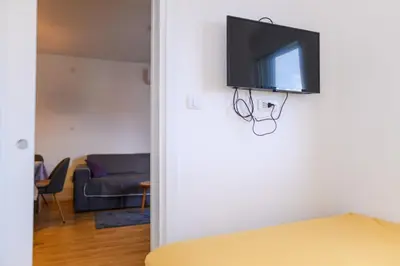 a flat screen tv hanging on a wall in a living room at Viktor i Kasija green hill in Soko Banja
