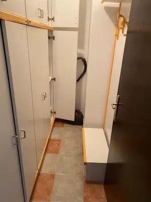 a hallway with white cabinets and a tiled floor at Kopaonik- Vila Ivana in Kopaonik