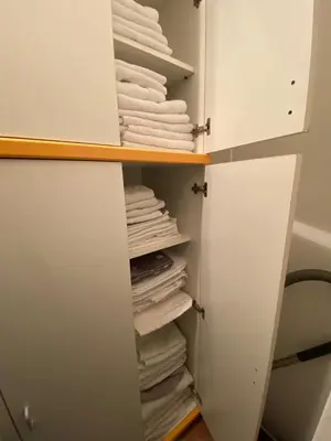 a closet filled with white towels and a stack of towels at Kopaonik- Vila Ivana in Kopaonik