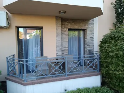 a balcony with a blue railing on a house at Apartman Savić Solaris in Vrnjci