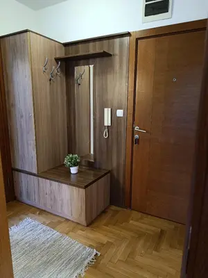 a room with a wooden door and a potted plant at Apartman Savić Solaris in Vrnjci