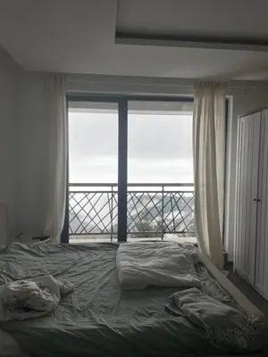 a bedroom with a bed and a large window at Residence Hills Lux Hotels & Spa Kopaonik in Kopaonik