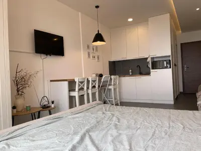 a bedroom with a large bed and a kitchen at Residence Hills Lux Hotels & Spa Kopaonik in Kopaonik