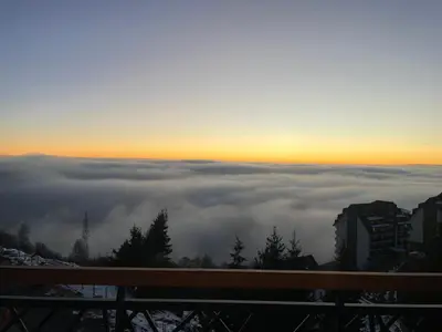 a view of the sun rising above the clouds at Residence Hills Lux Hotels & Spa Kopaonik in Kopaonik