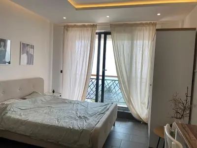 a bedroom with a bed and a large window at Residence Hills Lux Hotels & Spa Kopaonik in Kopaonik