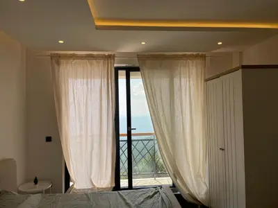 a bedroom with a bed and a large window at Residence Hills Lux Hotels & Spa Kopaonik in Kopaonik