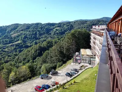 a view of a building with cars parked in a parking lot at Emili N90a in Cajetina