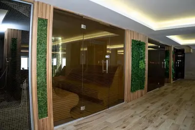 a building with a glass wall with stairs in it at Emili N90a in Cajetina
