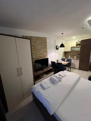 a bedroom with a bed and a living room at Emili N90a in Cajetina