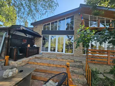 a house with a patio with a table and chairs at Bear Secret House in Ćuprija