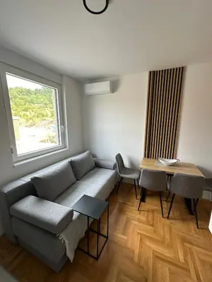 a living room with a couch and a table at Apartman Iznad Sunca in Soko Banja