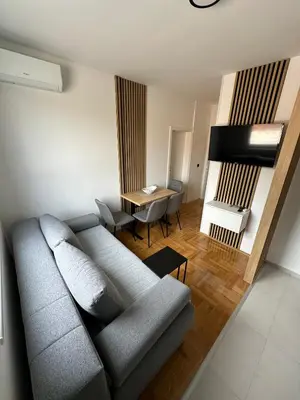 a living room with a couch and a table at Apartman Iznad Sunca in Soko Banja