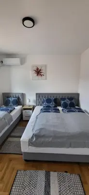 a bedroom with a large bed with blue pillows at Apartman Iznad Sunca in Soko Banja