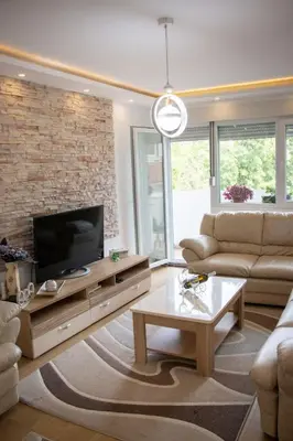a living room with a couch and a tv at Apartman Emilija i Julija in Soko Banja