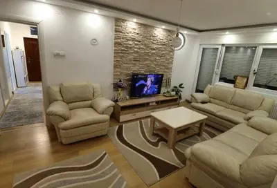 a living room with a couch and chairs and a tv at Apartman Emilija i Julija in Soko Banja