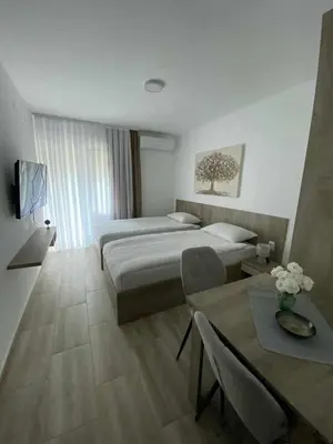 a hotel room with a bed and a table at Smeštaj Gligorijević in Lukovo