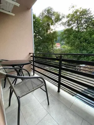 a balcony with a table and a chair and a window at Smeštaj Gligorijević in Lukovo