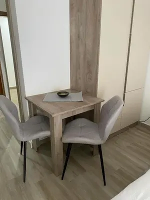a wooden table with two chairs and a plate on it at Smeštaj Gligorijević in Lukovo