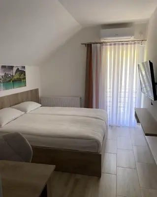 a bedroom with a large bed and a window at Smeštaj Gligorijević in Lukovo