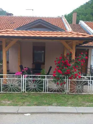 a house with a fence with flowers on it at Smeštaj Gligorijević in Lukovo