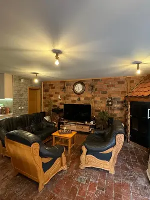a large living room with couches and a tv at Ognjište in Prokuplje
