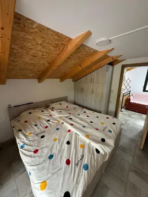 a bedroom with a large bed with rocks on it at Ognjište in Prokuplje