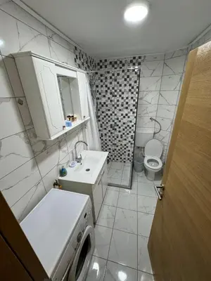 a bathroom with a sink and a washing machine at Ognjište in Prokuplje