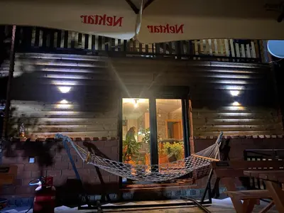 a hammock hanging on the side of a building at Ognjište in Prokuplje