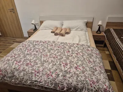 a bed with two pairs of shoes on it at Vila RUŽA - House of Roses in Soko Banja