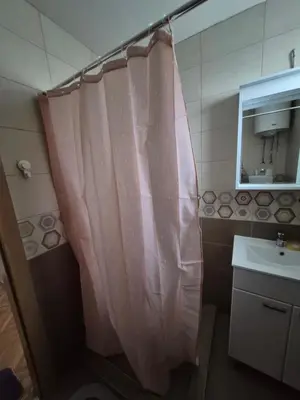 a bathroom with a shower curtain and a sink at Vila RUŽA - House of Roses in Soko Banja