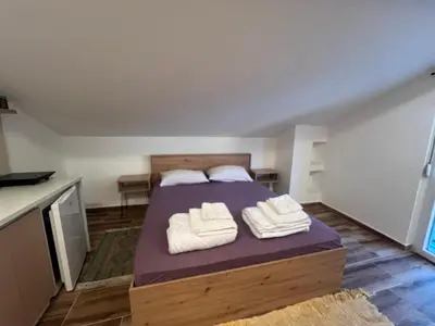 a bedroom with a bed with towels on it at Vila RUŽA - House of Roses in Soko Banja