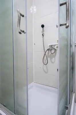 a shower with a glass door in a bathroom at Family House in Leskovac