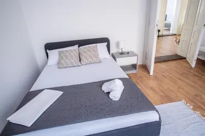 a bedroom with a large bed with at Family House in Leskovac