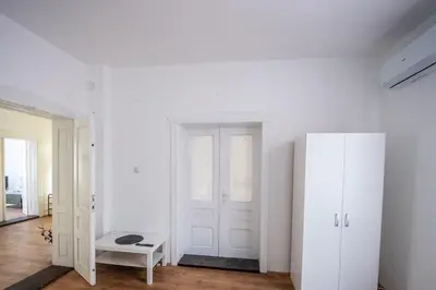 a white room with a door and a white cabinet at Family House in Leskovac