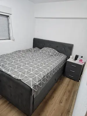 a bedroom with a bed and a night stand at Oki in Gornje Stopanje