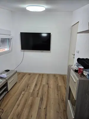 a living room with a flat screen tv on a wall at Oki in Gornje Stopanje