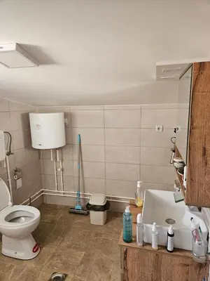 a bathroom with a toilet and a sink at Oki in Gornje Stopanje