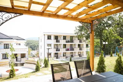 an outdoor patio with a view of a building at Grey Apartment On the Hill in Vrnjačka Banja