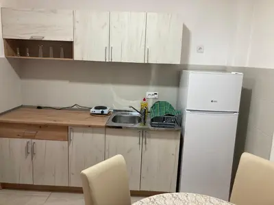 a small kitchen with a sink and a refrigerator at Apartman Raj in Vrnjci
