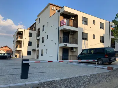 a van parked in a parking lot in front of a building at Apartman Raj in Vrnjci